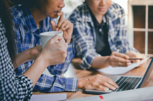 Close-up of  business people working on project together. Teamwork , hipster tone