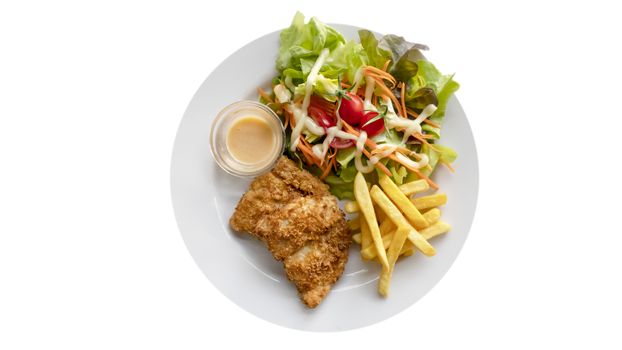 Deep fried fish steak served with french fries and fresh vegetables on white plate