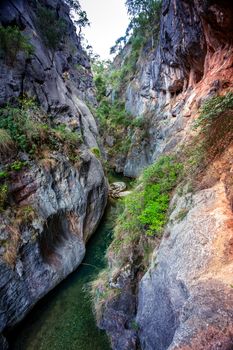 Canyon filled with crystal clear water, its depth is deceiving and varies along its length