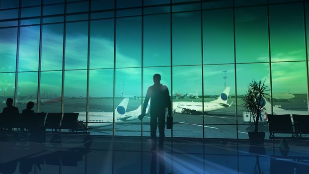Silhouette of a businessman standing by the window at the airport before the flight.