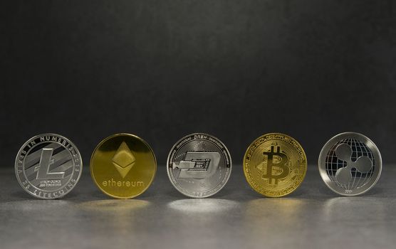 a litecoin and ethereum and dash and bitcoin and ripple together for a black background ,Coins of the four crypto currencies with the highest market capitalization
