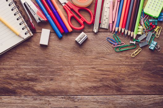 School supplie placed on a wood background concept ready for school.