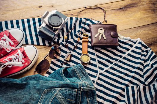 Travel accessories and costume on wooden floor