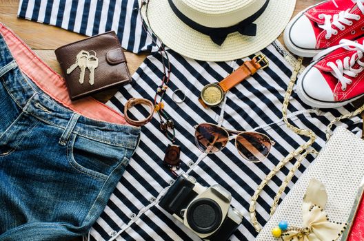 Travel accessories and costume on wooden floor