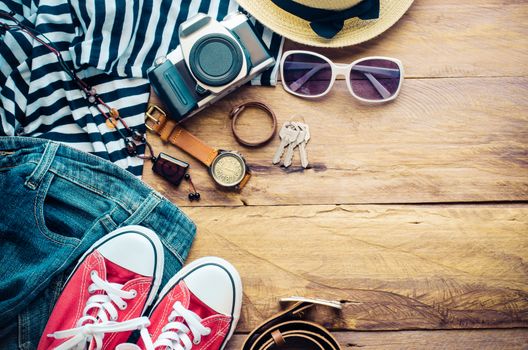 Travel accessories and costume on wooden floor