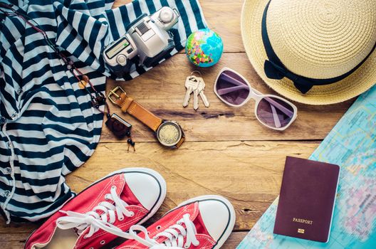 Travel accessories and costume on wooden floor