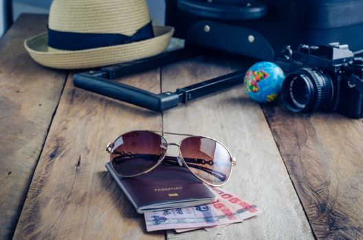 Luggage accessories passport and money on the wooden floor