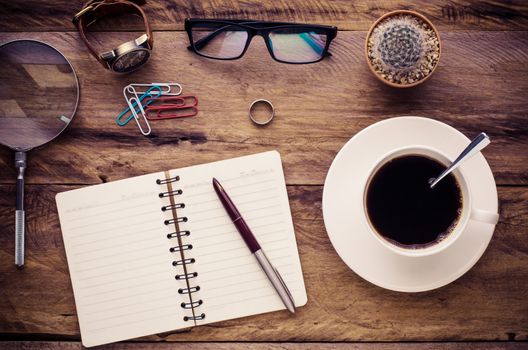 costume calculator, pen, notebook and accessory for work on wooden table.