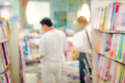 focused/Blur image of a bookstore with customers reading and looking for books. Bookstore background.