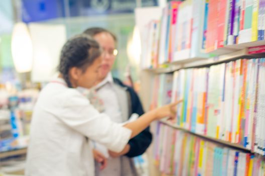 focused/Blur image of a bookstore with customers reading and looking for books. Bookstore background.