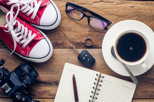 Planning for trip clothing and accessories on wood floor
