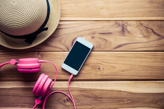 hats smart phone earphone on wood