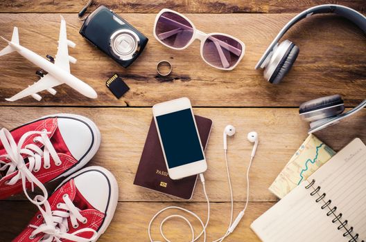 Tourism planning and equipment needed for the trip on wooden floor