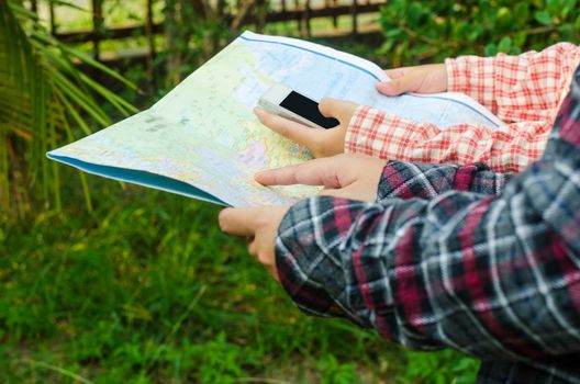 view of a young planning a journey looking at a map
