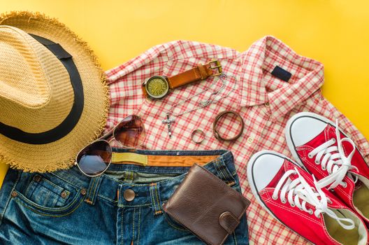 Clothing and accessories for trip on yellow floor