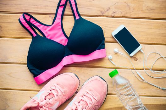 fitness concept with Exercise Equipment on wooden background.