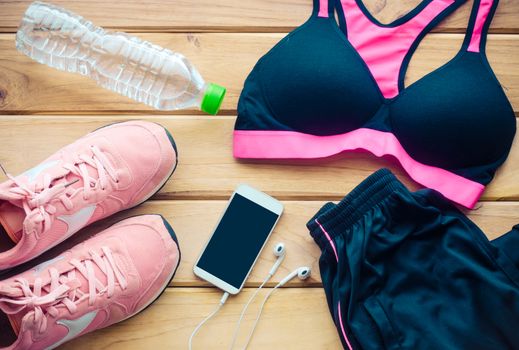 fitness concept with Exercise Equipment on wooden background.