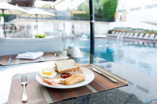 Delicious Breakfast set by the swimming pool at Pattaya, Thailand