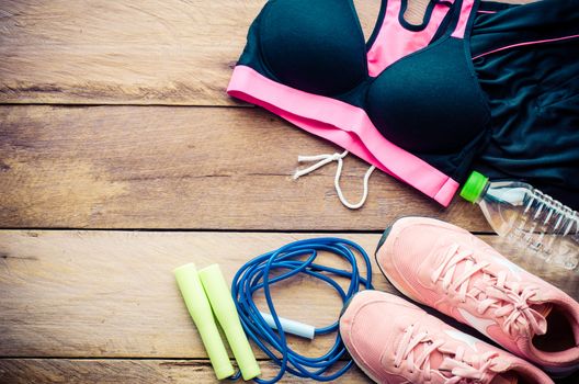 fitness concept with Exercise Equipment on wooden background.