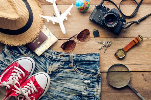 Travel accessories and costume on wooden floor