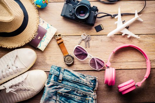 Travel accessories and costume on wooden floor