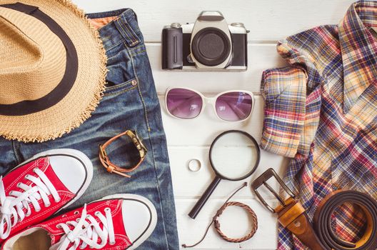 Travel accessories and costume on white background