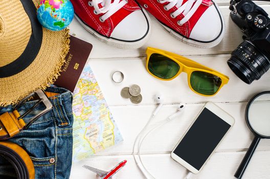 Travel accessories and costume on white background