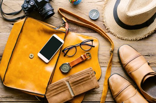 Clothing and accessories for men on wood floor