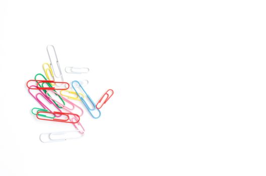 Colored paper clips on a white background.