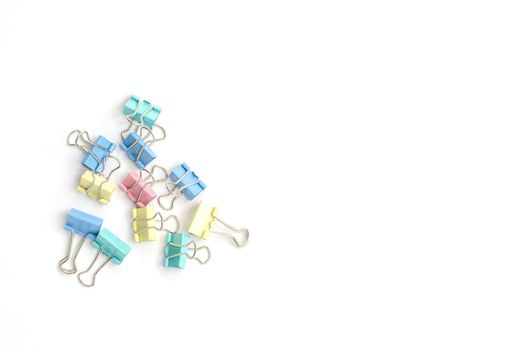 Colored paper clips on a white background.