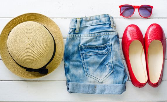 jeans shoes sunglasses for girl teen on white wooden floor