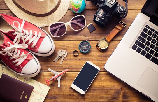 Tourism planning and equipment needed for the trip on wooden floor
