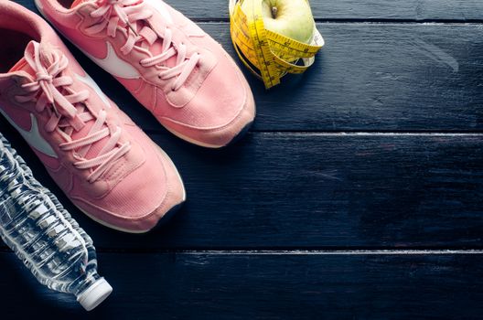 fitness concept with Exercise Equipment on wooden background.