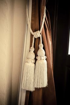 Curtains tied with white tassel.