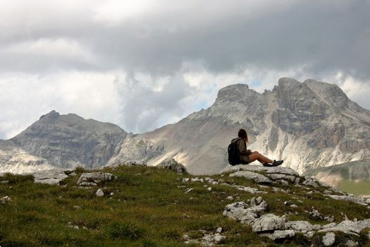 a girl admiting landscpae of Dolomites, at Puez Odle natural park,  in  Alto Adige, Val Badia