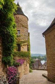  The picturesque village of La Roque Gageac backed by the cliff and reflecting in Dordogne river