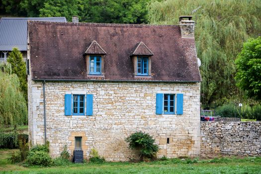 nise little house with blue windows at saint amand de coly , perigord noir in aquitaine, france