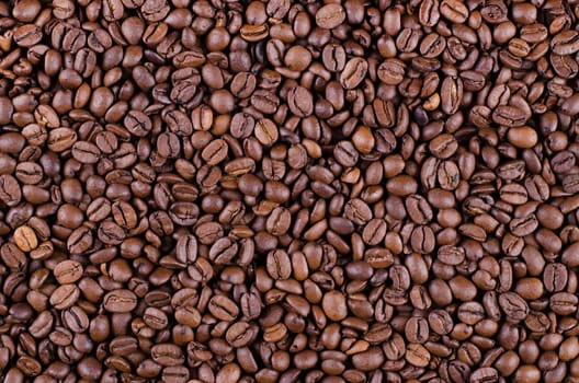 Background of coffee beans. Dropped brown coffee beans.
