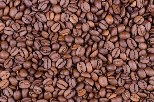 Background of coffee beans. Dropped brown coffee beans.