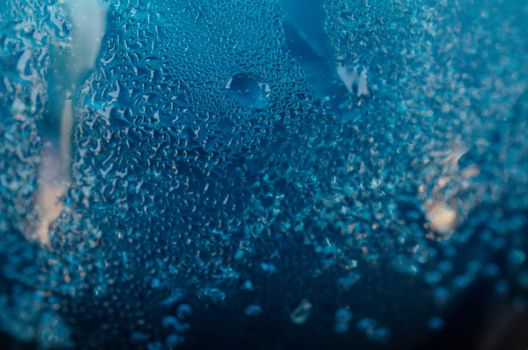 Close up water drops on blue tone background