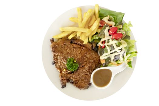 Grilled steak with french fries and fresh vegetables on white plate