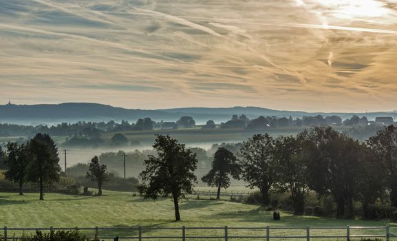morning landscape with the hills in belgium with mist meadow 