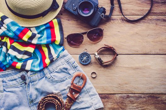 Travel Clothing accessories Apparel along on wooden floor 