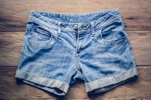 Jeans shorts on the wooden floor. 