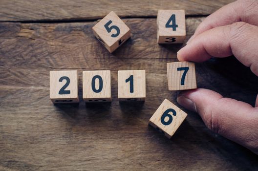 Hand change wood block 2017 on wooden - new year concept