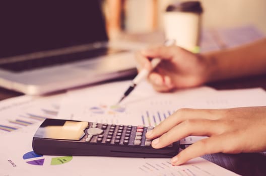 Businessman are working with a calculator and laptop. in office business concept 
