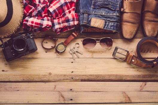 Travel Clothing accessories Apparel along on wooden floor 