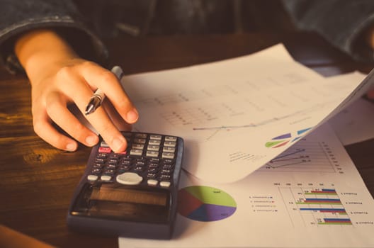 Businessman are working with a calculator and laptop. in office business concept 