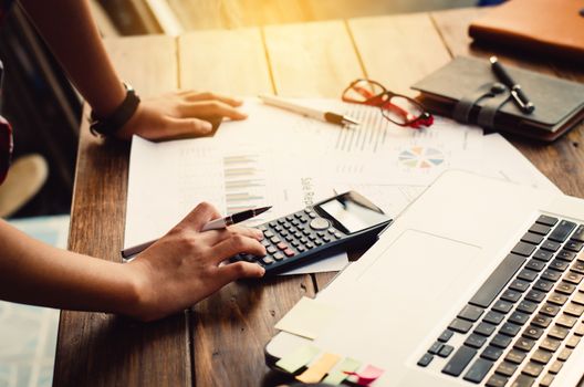 Businessman are working with a calculator and laptop. in office business concept 