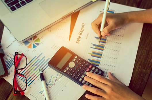 Businessman are working with a calculator and laptop. in office business concept 